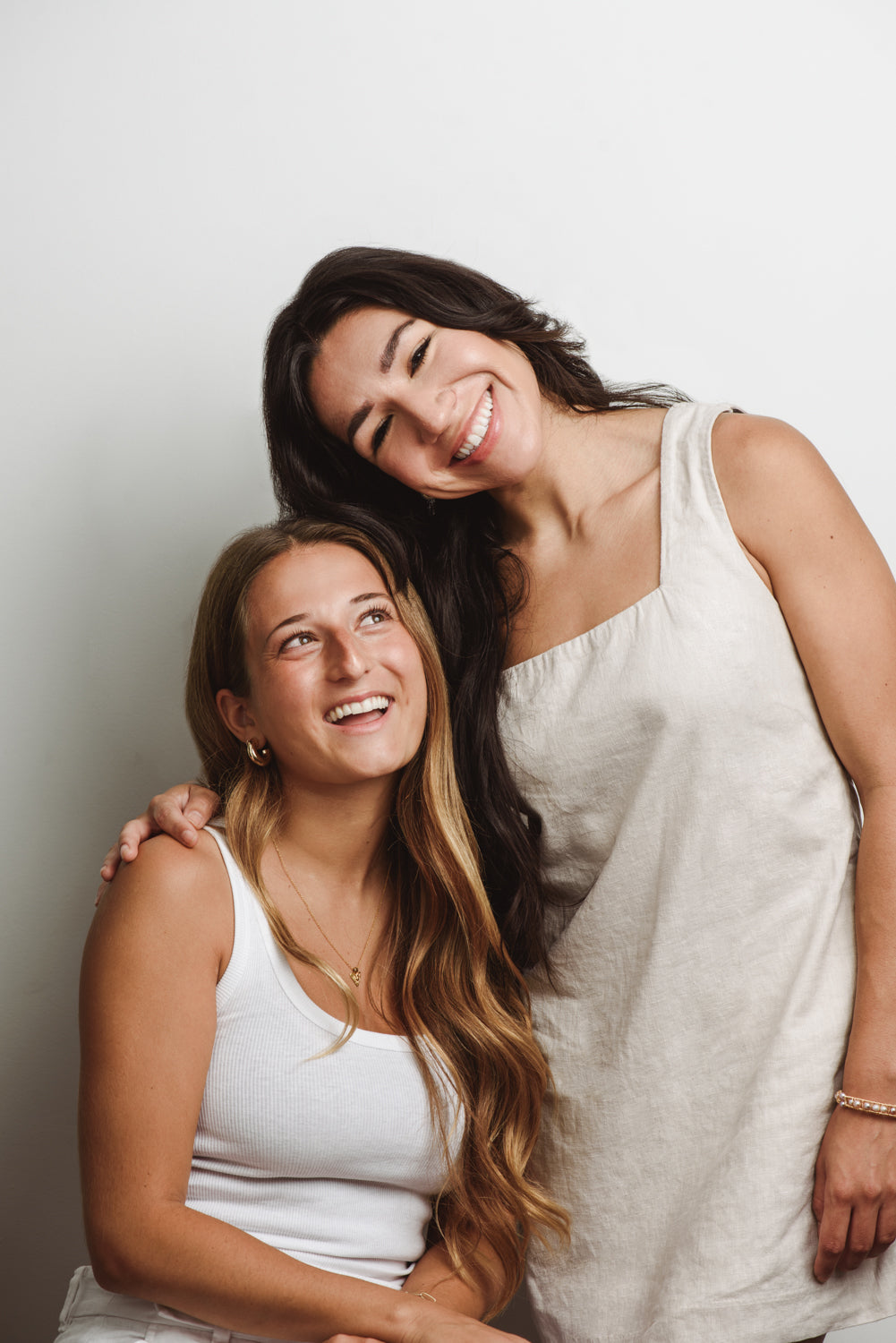 Smiling friends celebrating with Neat Studio’s referral program, earning a $50 gift card for every successful referral